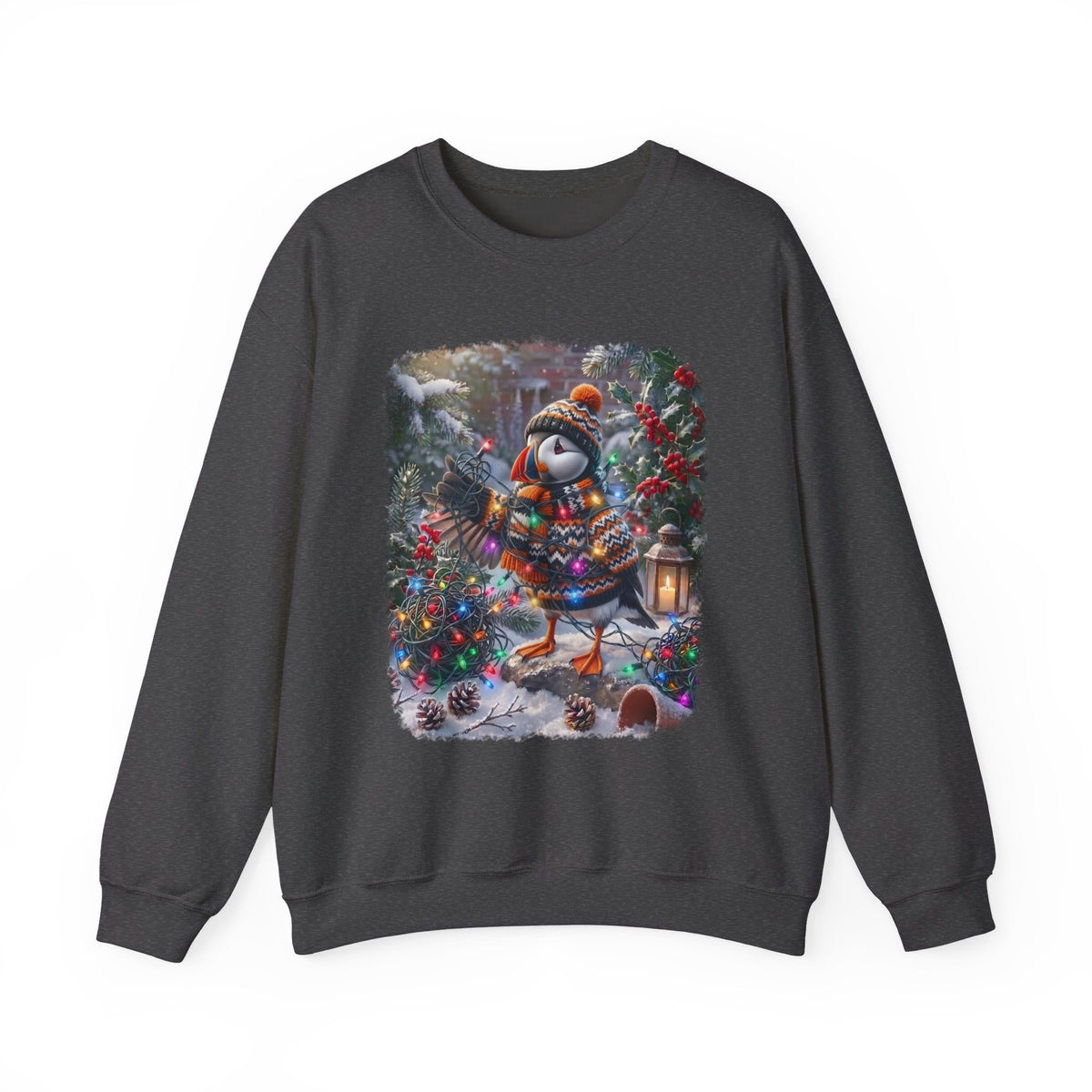 A dark gray crewneck sweatshirt featuring a colorful graphic print of a puffin dressed in winter clothing and a hat, holding Christmas lights amidst Christmas trees and snow.