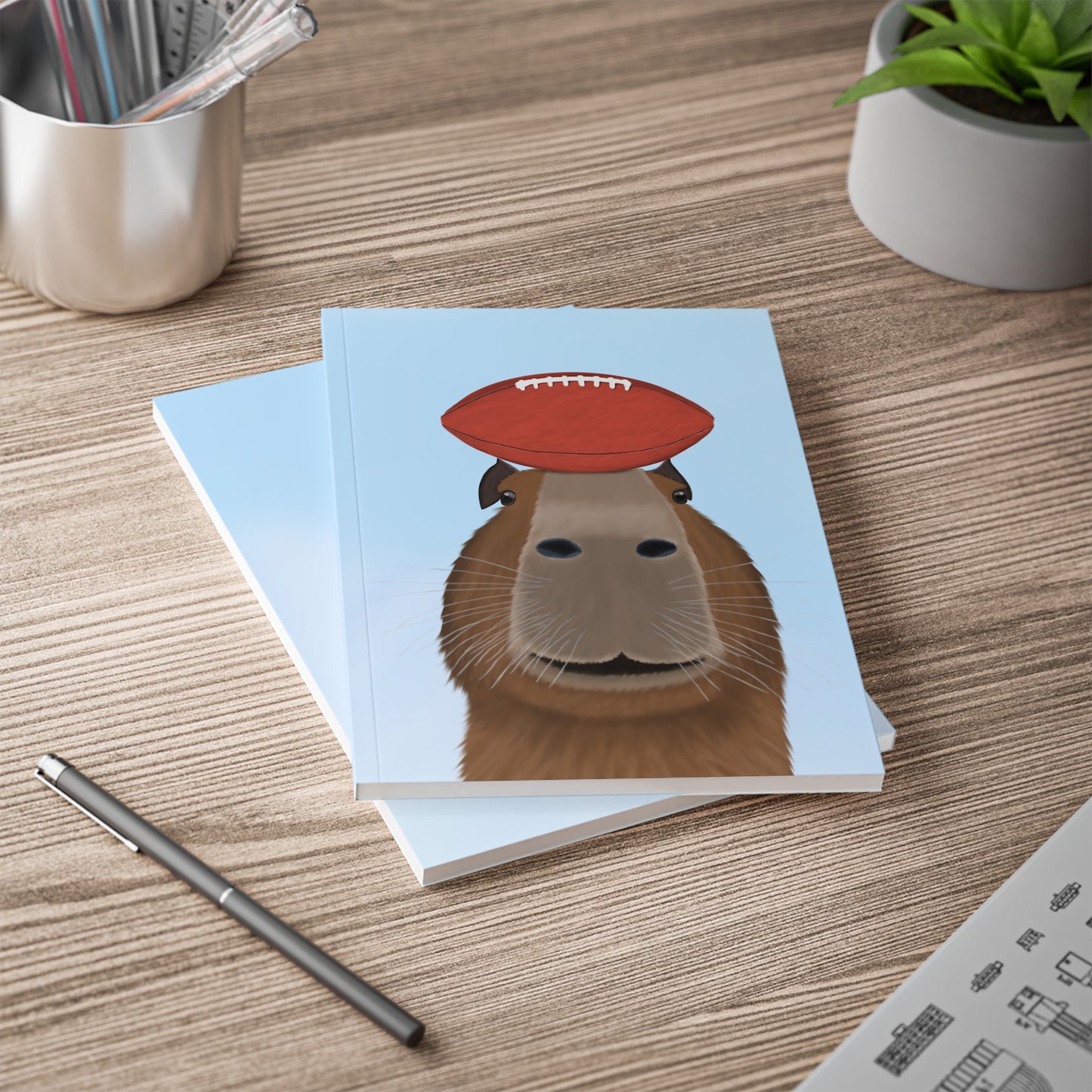 Capybara mit Football A5 Softcover Notizbuch 150 Seiten Liniert