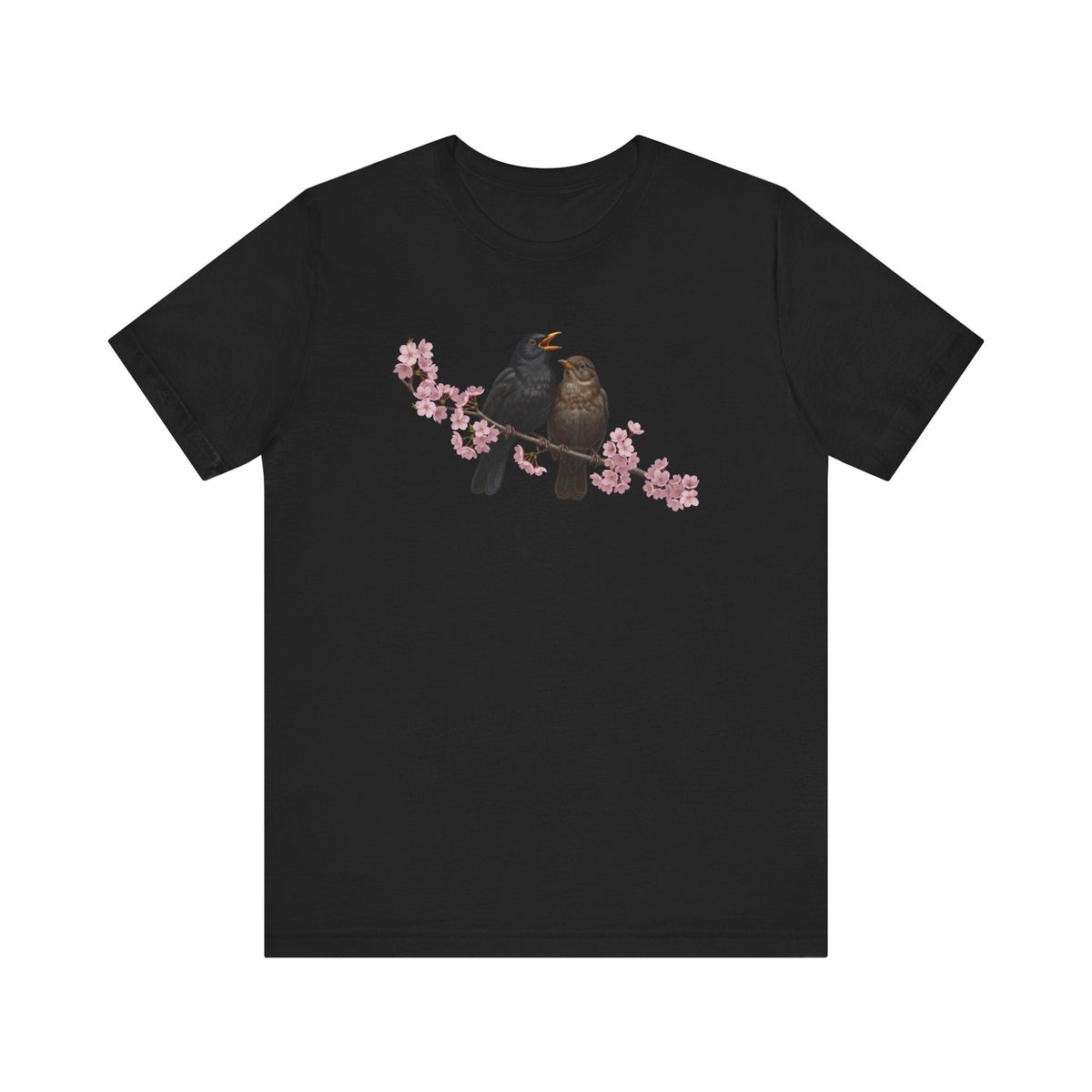 Black t-shirt with a graphic of two birds on a branch with pink flowers on a white background
