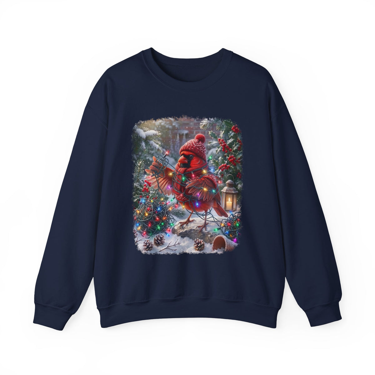 A navy blue crewneck sweatshirt featuring a large square graphic print on the front. The graphic depicts a festive Christmas scene with a red cardinal wearing a red knit hat and scarf, standing in a snowy yard decorated with a lit Christmas tree and a lantern.