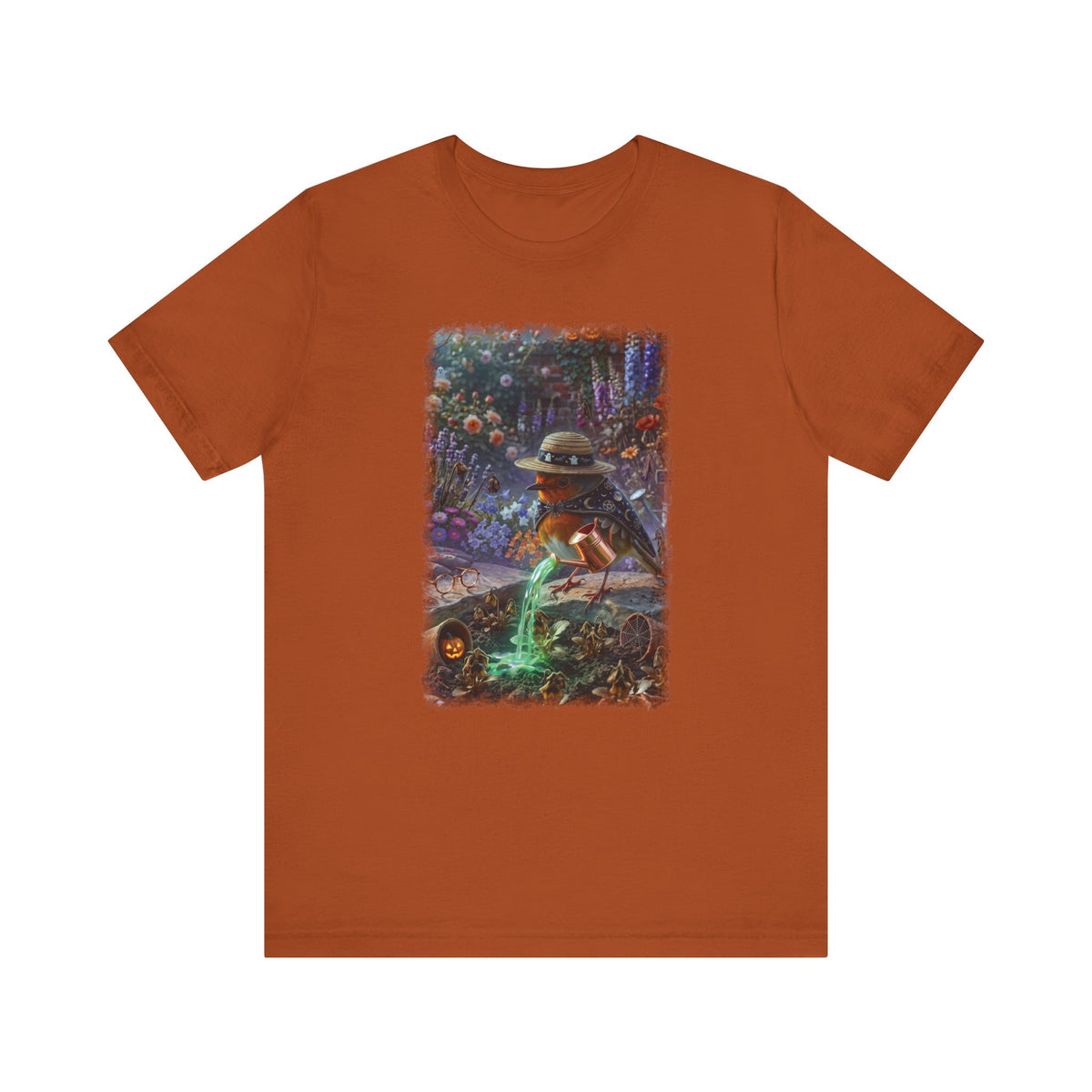 Soft premium Bella Canvas 3001 autumn colored T-shirt featuring a digitally painted illustration of a cute bird named Robin Rosi pouring a glowing green magic potion from a watering can onto dried flowers.