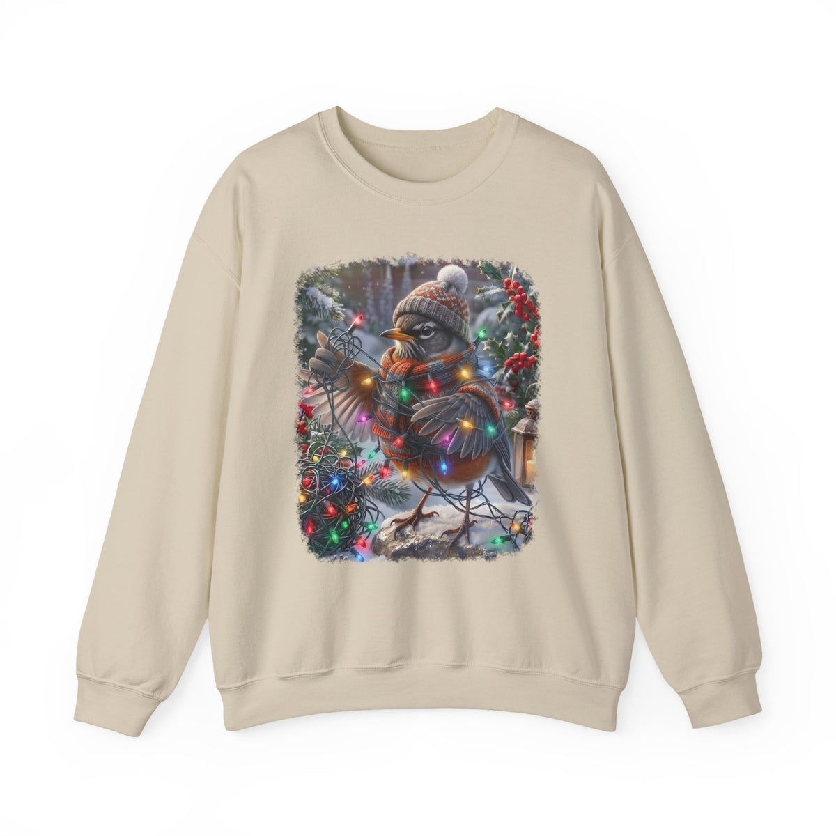 A beige crewneck sweatshirt featuring a square graphic print of a robin decorated for Christmas with a knit hat, scarf, and colorful holiday lights, set against a plain white background.
