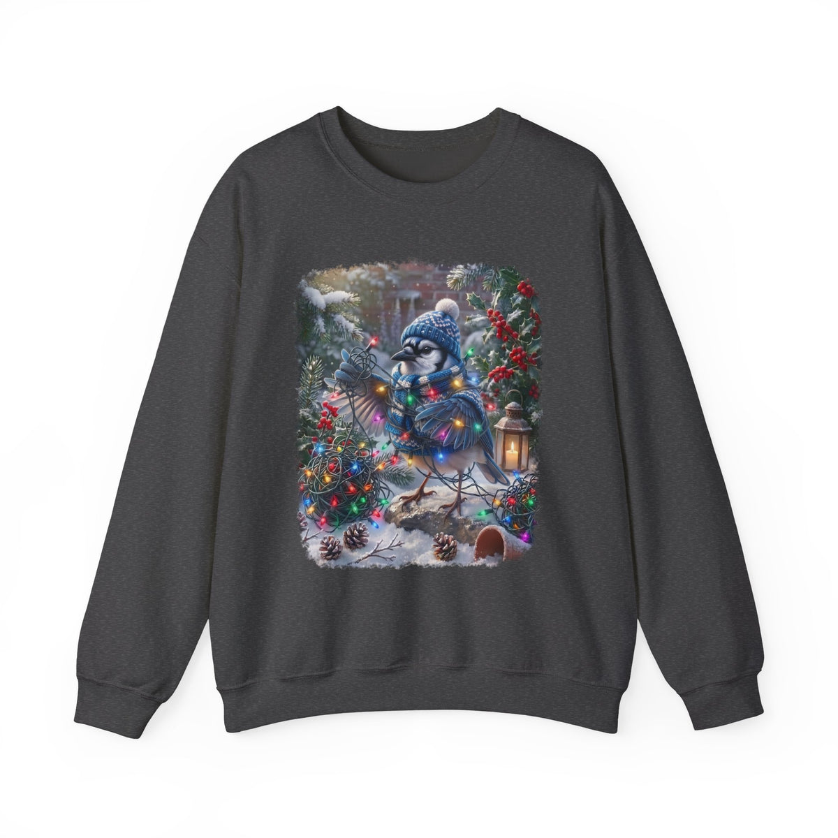 A dark gray crewneck sweatshirt featuring a large, colorful graphic print of a blue jay wearing a winter hat and scarf, nestled among decorated Christmas trees and pinecones in a snowy outdoor scene.