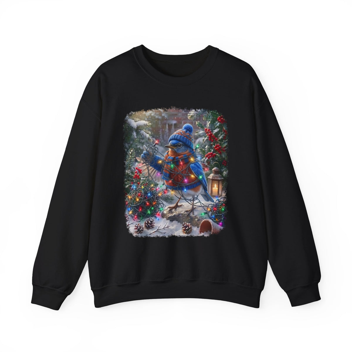 A black crewneck sweatshirt featuring a large, colorful graphic print on the front of a blue bird dressed in winter clothing, surrounded by Christmas trees, ornaments, and warm holiday lights.