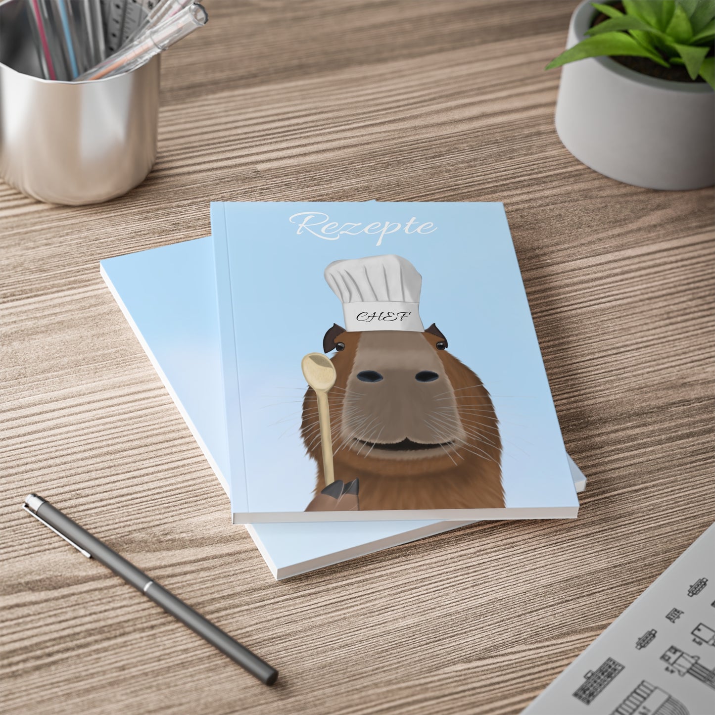 Capybara mit Kochmütze und Kochlöffel A5 Softcover Notizbuch 150 Seiten Liniert