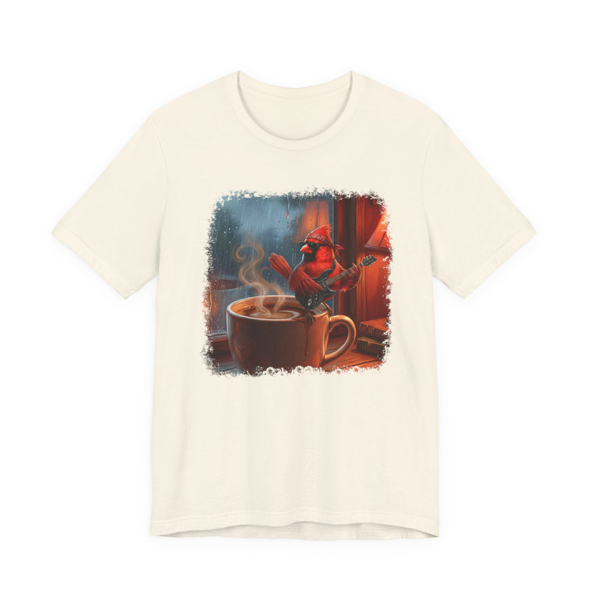 Beige t-shirt with a graphic of a cardinal by a steaming cup of coffee on a white background