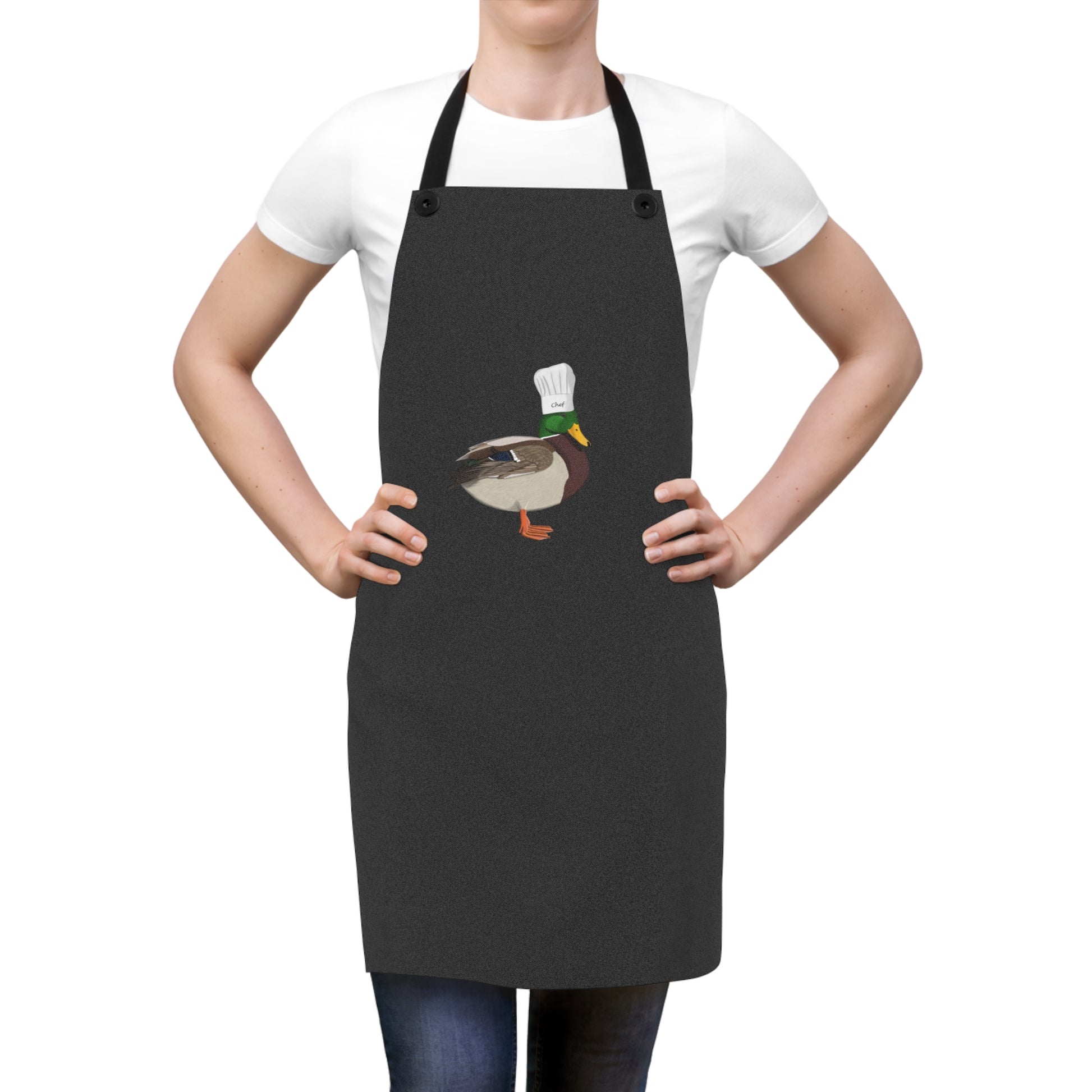 Person wearing a black apron with a duck design on a white background