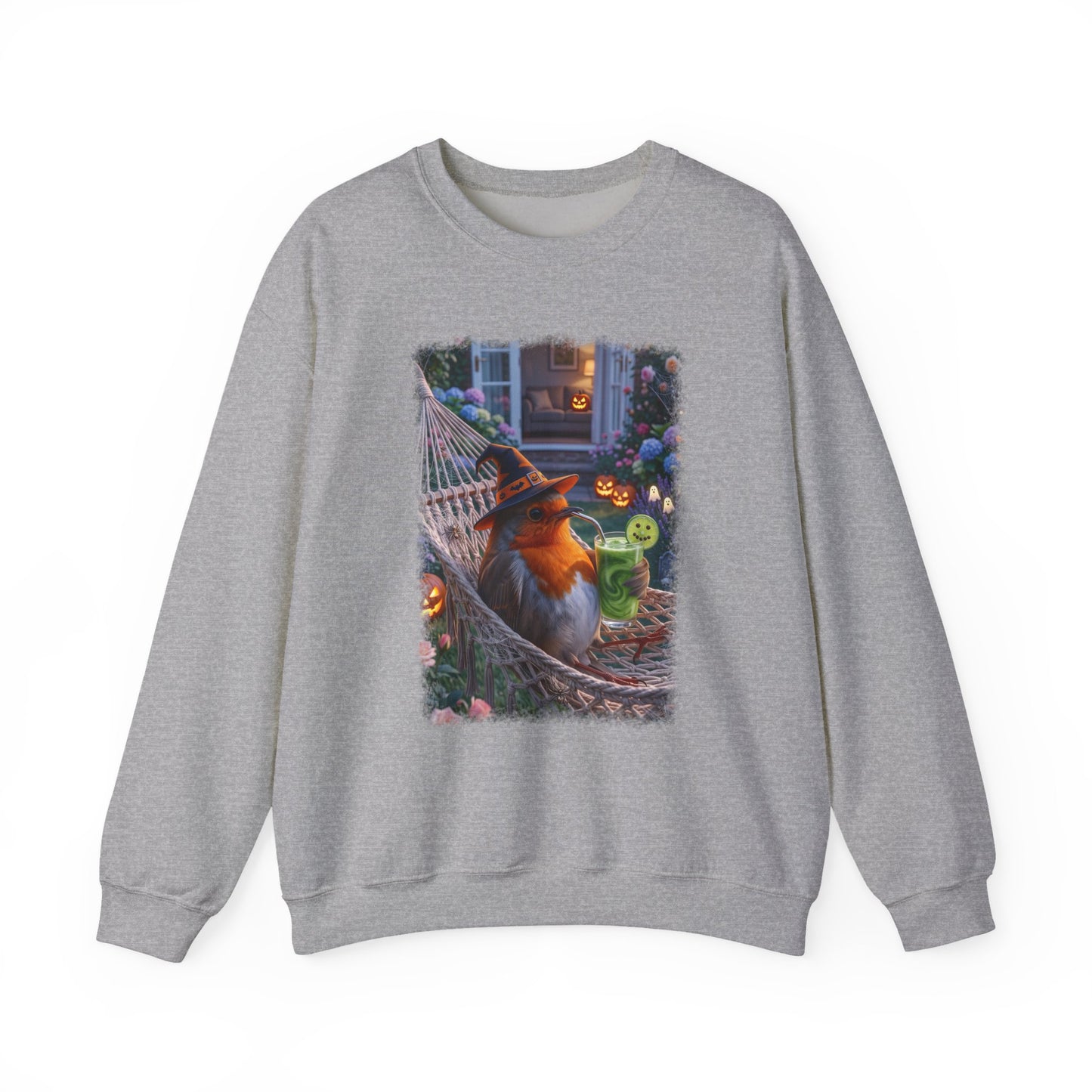 A heather gray crewneck sweatshirt featuring a large graphic print of a robin bird wearing a witch hat and sunglasses, relaxing in a hammock surrounded by Halloween decorations.