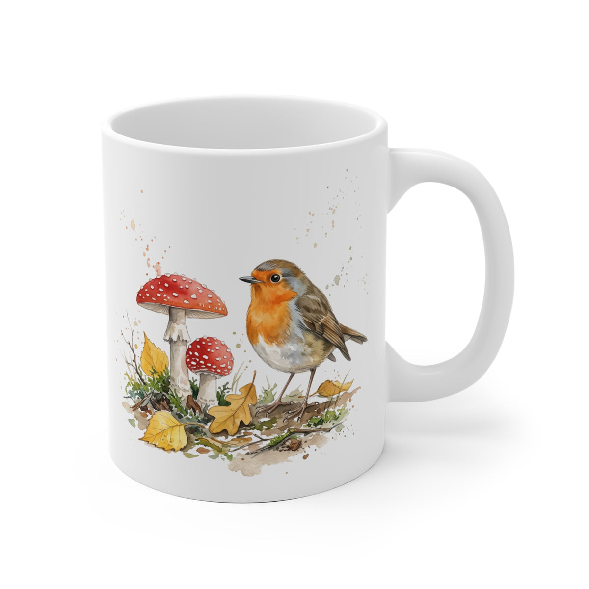 Weiße Keramiktasse mit einem gemalten Rotkehlchen im herbstlichen Laub und roten Fliegenpilzen – gemütlicher Kaffeebecher für Vogelfreunde