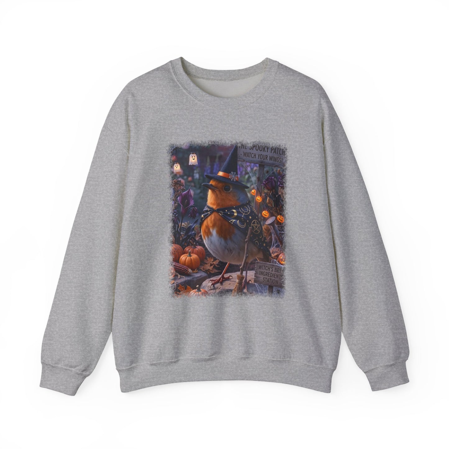 A heather gray crewneck sweatshirt featuring a large, colorful graphic print of a robin wearing a witch's hat in a spooky pumpkin patch scene.