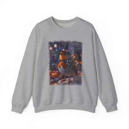A heather gray crewneck sweatshirt featuring a large, colorful graphic print of a robin wearing a witch's hat in a spooky pumpkin patch scene.