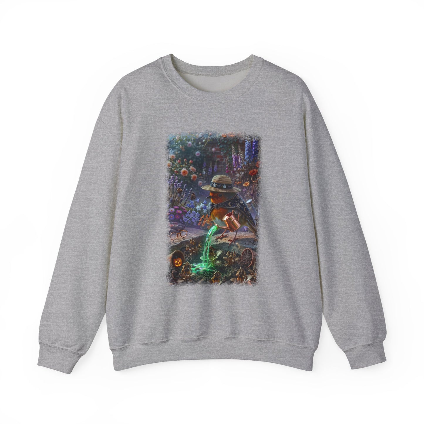 A heather gray crewneck sweatshirt featuring a large rectangular graphic print on the front. The graphic depicts a spooky scene with a robin bird in a hat watering a patch of green grass next to a pumpkin patch.