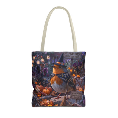 A tote bag with white shoulder straps, featuring a detailed Halloween illustration of a robin bird in a witch hat and bow tie, surrounded by pumpkins, lanterns, and spooky foliage.
