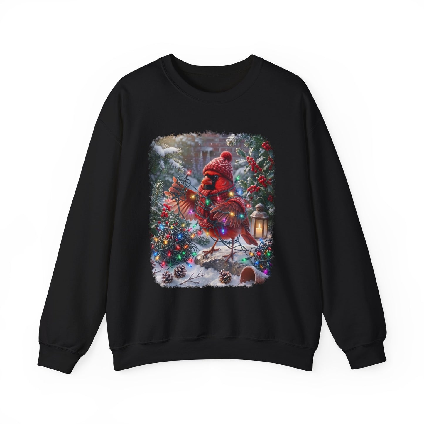 A black crewneck sweatshirt featuring a large, colorful graphic print of a Christmas cardinal wearing a red knit hat and scarf, standing in a snowy winter garden decorated with lights and ornaments.