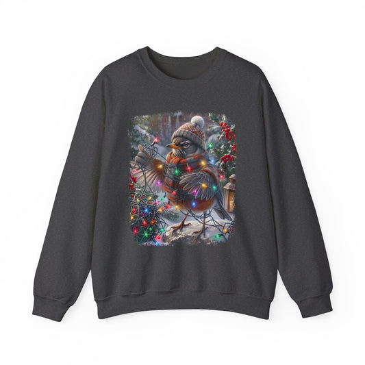 A dark gray crewneck sweatshirt featuring a square graphic print of a robin bird wearing a knit hat and scarf, surrounded by Christmas lights and a snowy winter scene.