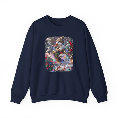 A navy blue crewneck sweatshirt featuring a large, colorful graphic print on the front of a snowy goose wearing a knit hat and scarf amidst winter foliage.