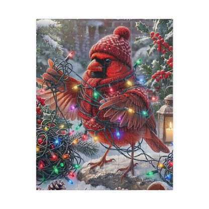 A square puzzle featuring a festive winter scene of a northern cardinal wearing a knit red hat and scarf, wrapped in multicolored Christmas lights, standing in snow with holly and berries.