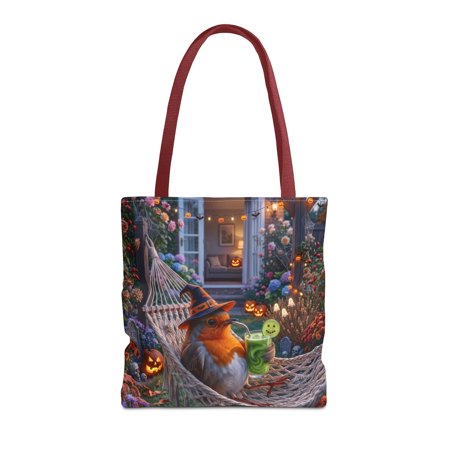 A tote bag with dark red handles, featuring a detailed Halloween-themed illustration of a robin bird in a witch hat relaxing in a hammock surrounded by glowing jack-o'-lanterns and flowers.