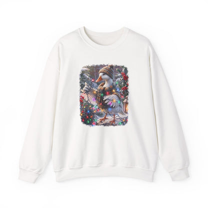 An off-white crewneck sweatshirt featuring a square graphic print on the chest of a snowy goose wearing a knit hat and scarf, surrounded by festive red berries and greenery.
