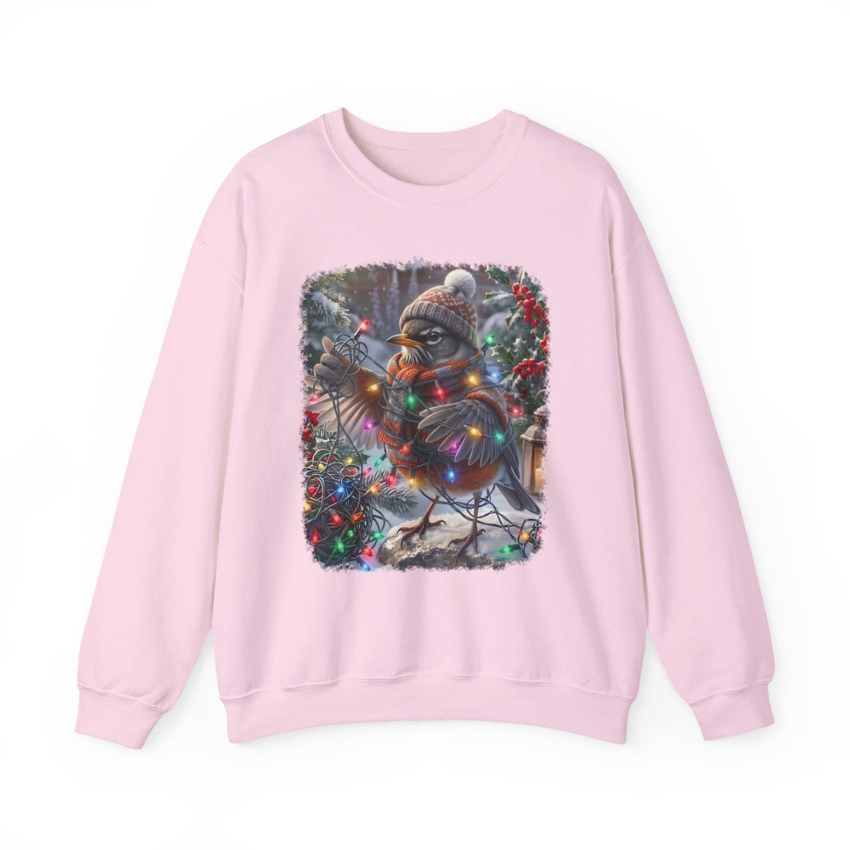 A light pink crewneck sweatshirt featuring a square graphic print of a robin bird wearing a knit Santa hat and scarf, surrounded by Christmas lights and mistletoe.