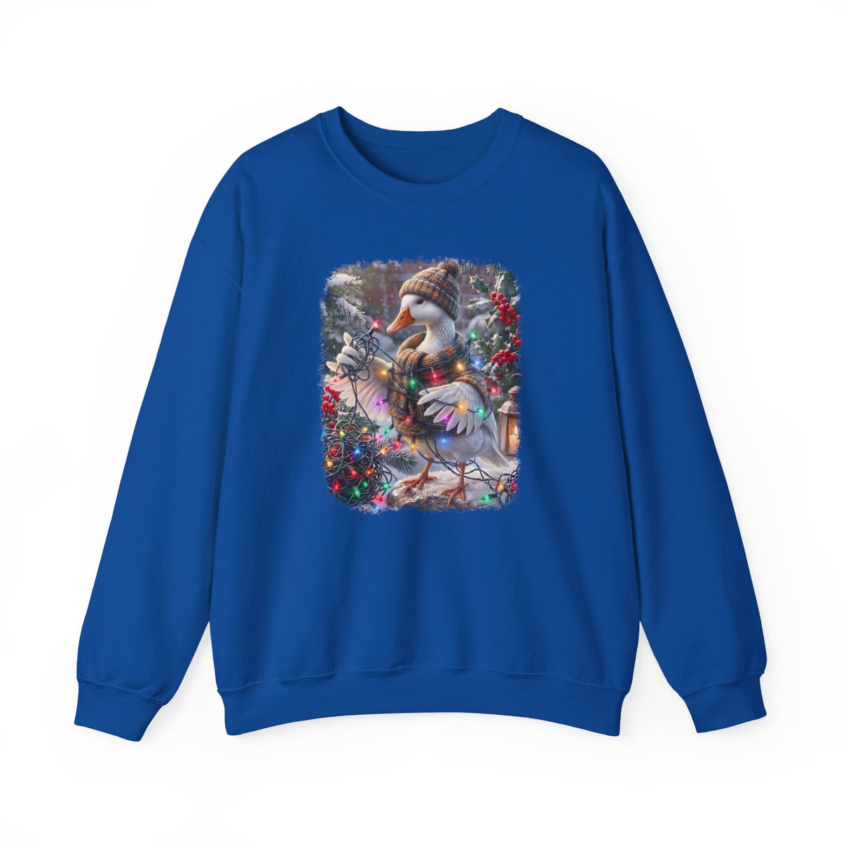 A royal blue crewneck sweatshirt featuring a square graphic print on the chest of a snowy goose wearing a knit hat and scarf, surrounded by festive red berries and greenery.