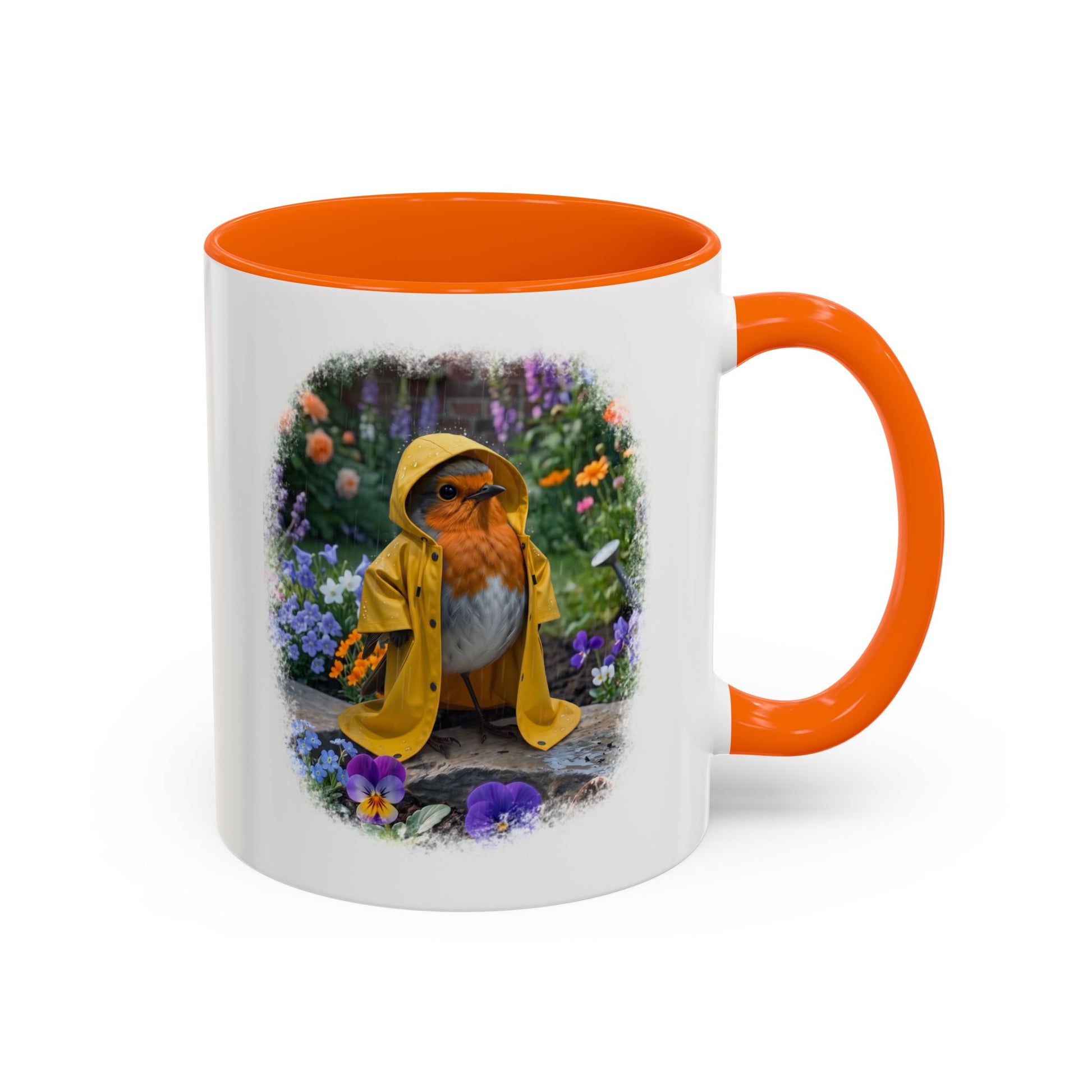 A white ceramic mug with a bright orange handle and interior, featuring a printed illustration of a robin wearing a yellow raincoat in a flower garden.