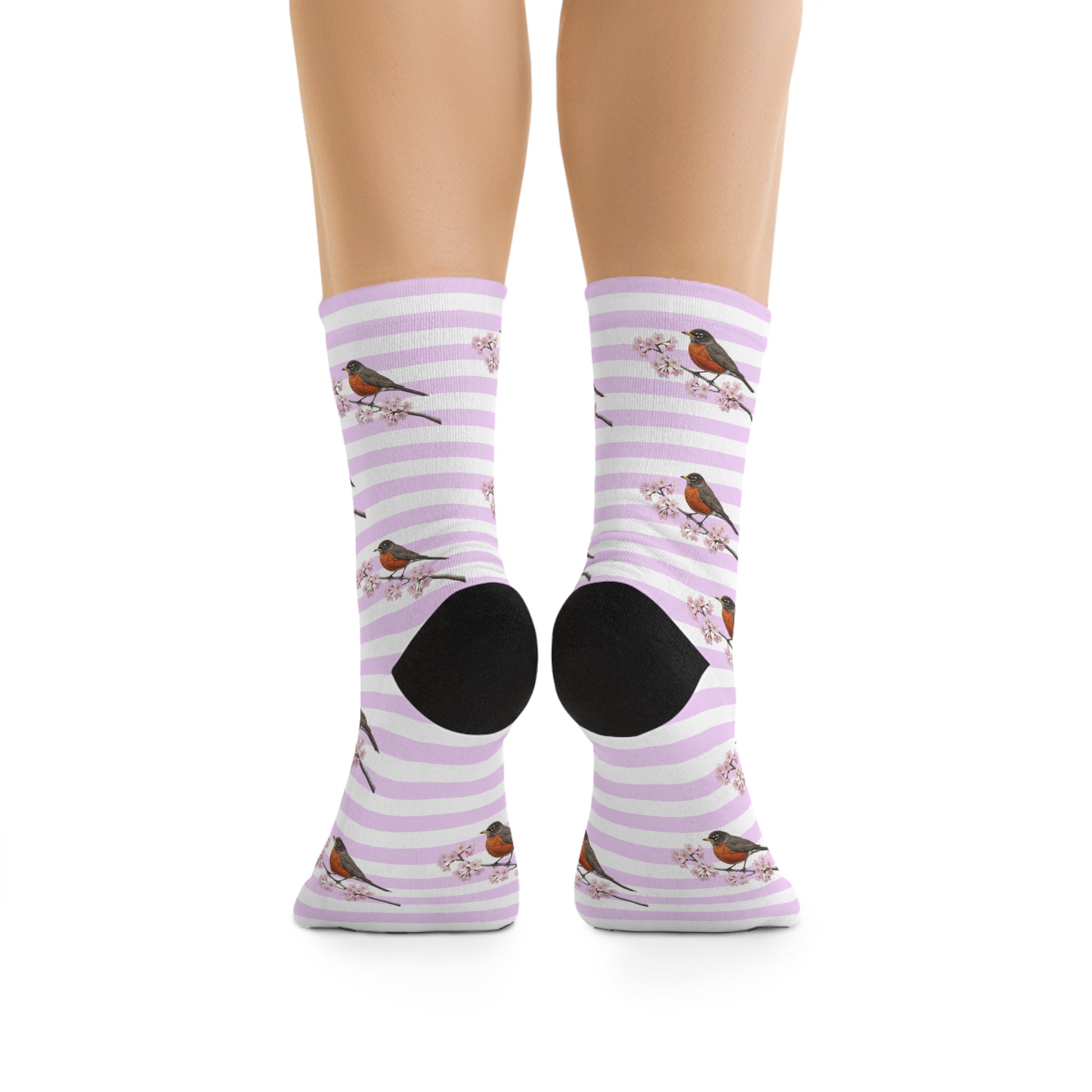 Purple striped socks with bird designs worn by a person on a white background