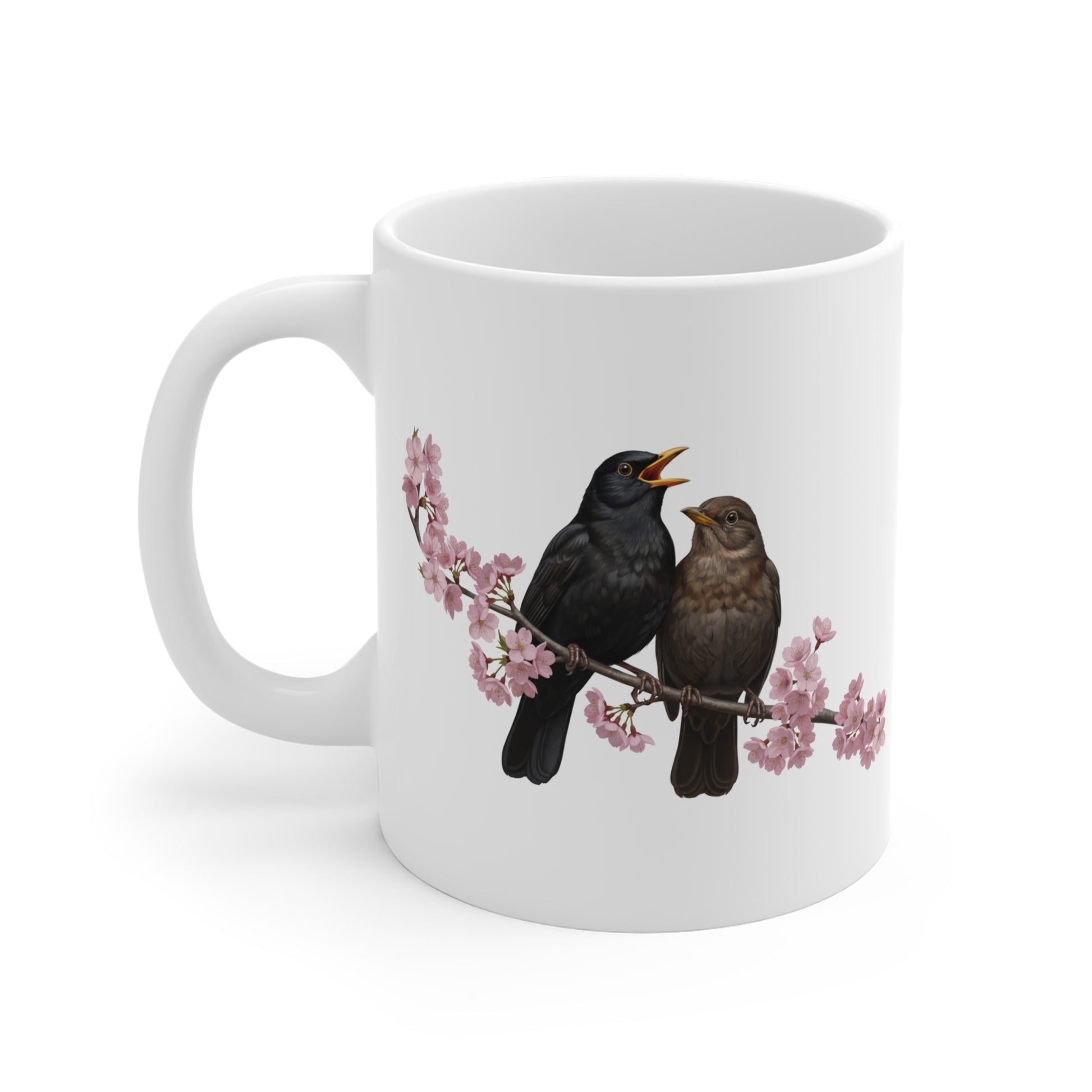 White mug with black birds on a branch design on a white background