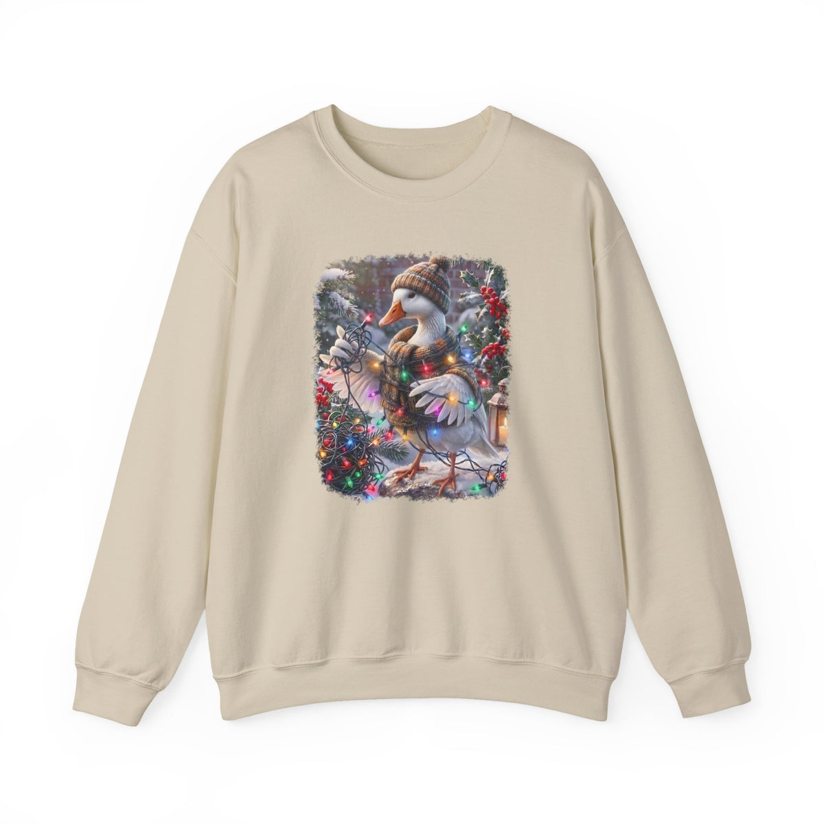 A beige crewneck sweatshirt featuring a square graphic print on the chest of a snowy goose wearing a knit hat and scarf, surrounded by festive Christmas decorations.