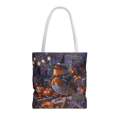 A tote bag with white shoulder straps, featuring a detailed Halloween illustration of a robin bird in a witch hat and bow tie, surrounded by pumpkins, lanterns, and spooky foliage.