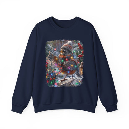 A navy blue crewneck sweatshirt featuring a large square graphic print on the front of a winter robin bird wearing a knit hat and scarf, surrounded by colorful Christmas lights and festive decorations.