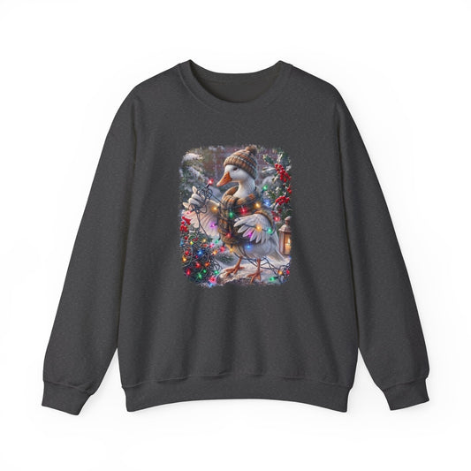 A dark gray crewneck sweatshirt featuring a colorful graphic print of a snowy goose wearing a knit hat and scarf, sitting on a decorated Christmas tree.