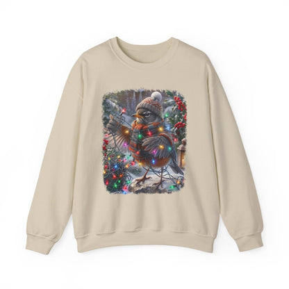A beige crewneck sweatshirt featuring a square graphic print of a robin decorated for Christmas with a knit hat, scarf, and colorful holiday lights, set against a plain white background.