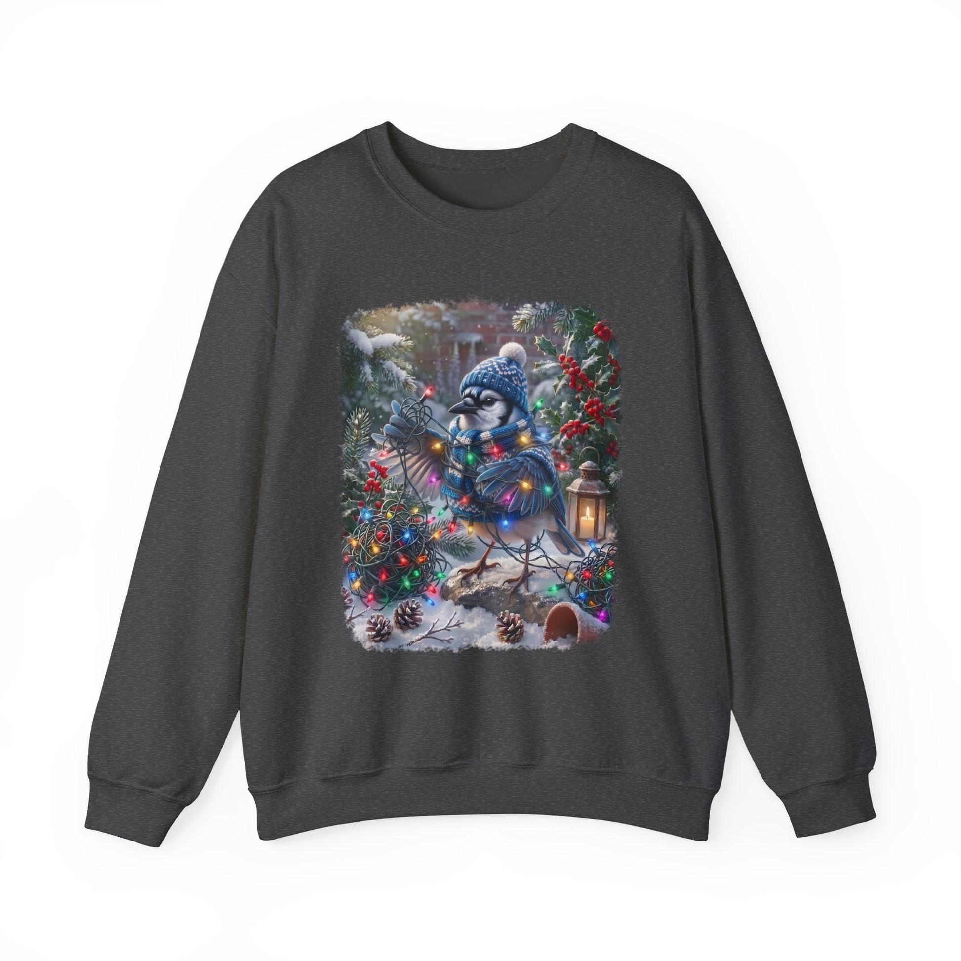 A dark gray crewneck sweatshirt featuring a large, colorful graphic print of a blue jay wearing a winter hat and scarf, nestled among decorated Christmas trees and pinecones in a snowy outdoor scene.
