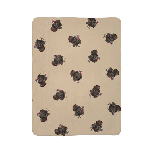 A rectangular beige blanket or mat with a repeating pattern of dark brown and black wild turkeys, shown flat against a solid white background.