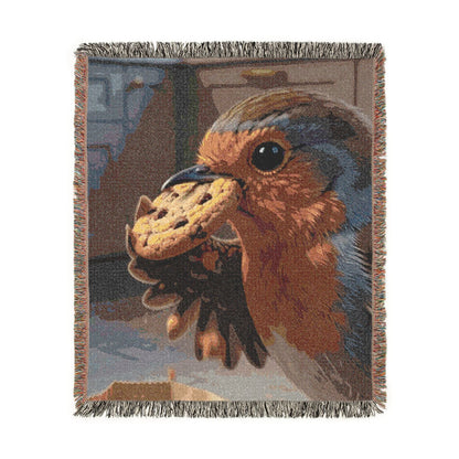 A woven throw blanket featuring a close-up tapestry-style illustration of a robin holding a cookie, with fringed edges on all sides.