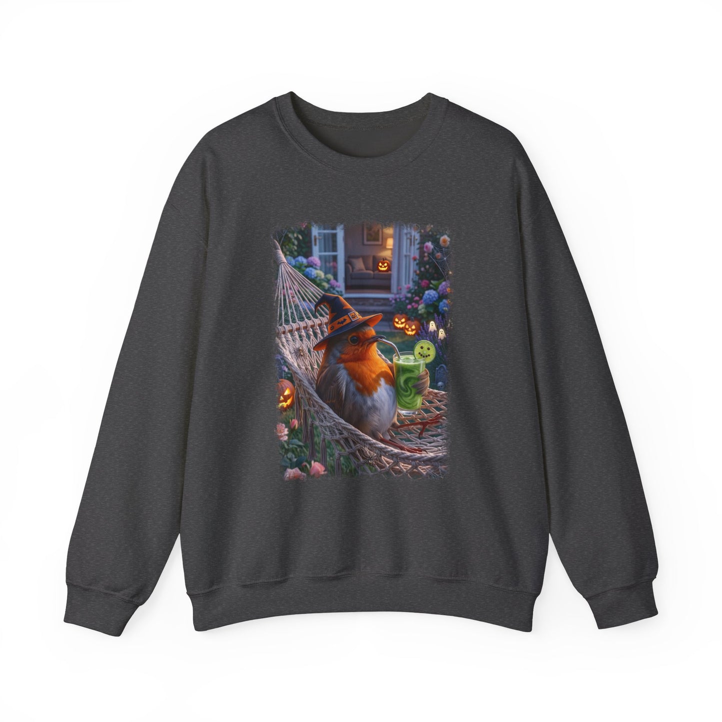A dark charcoal gray crewneck sweatshirt featuring a colorful graphic print of a robin bird dressed in a witch hat relaxing in a hammock surrounded by Halloween decorations.