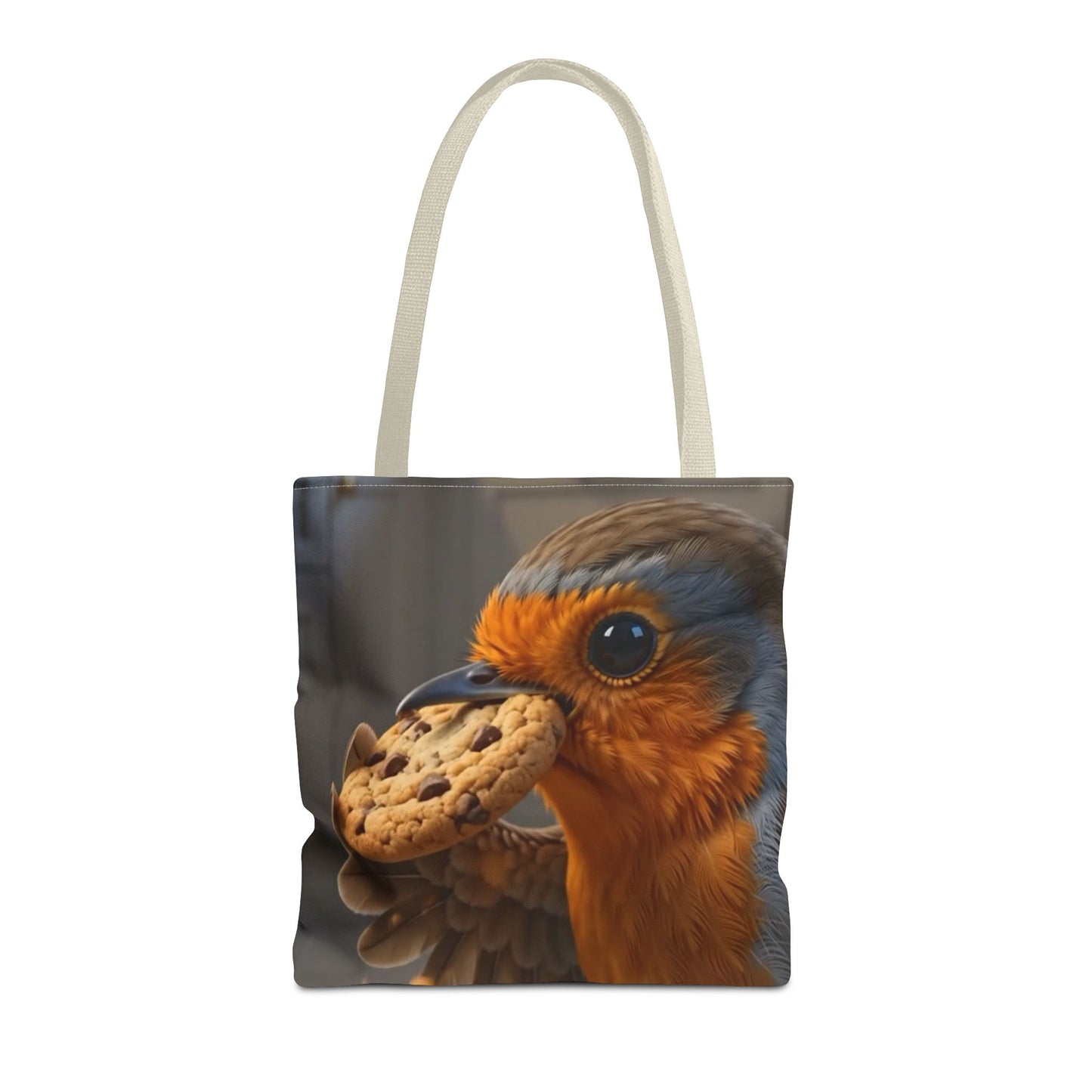 A white canvas tote bag featuring a printed graphic of a robin holding a chocolate chip cookie in its beak, set against a plain white background.
