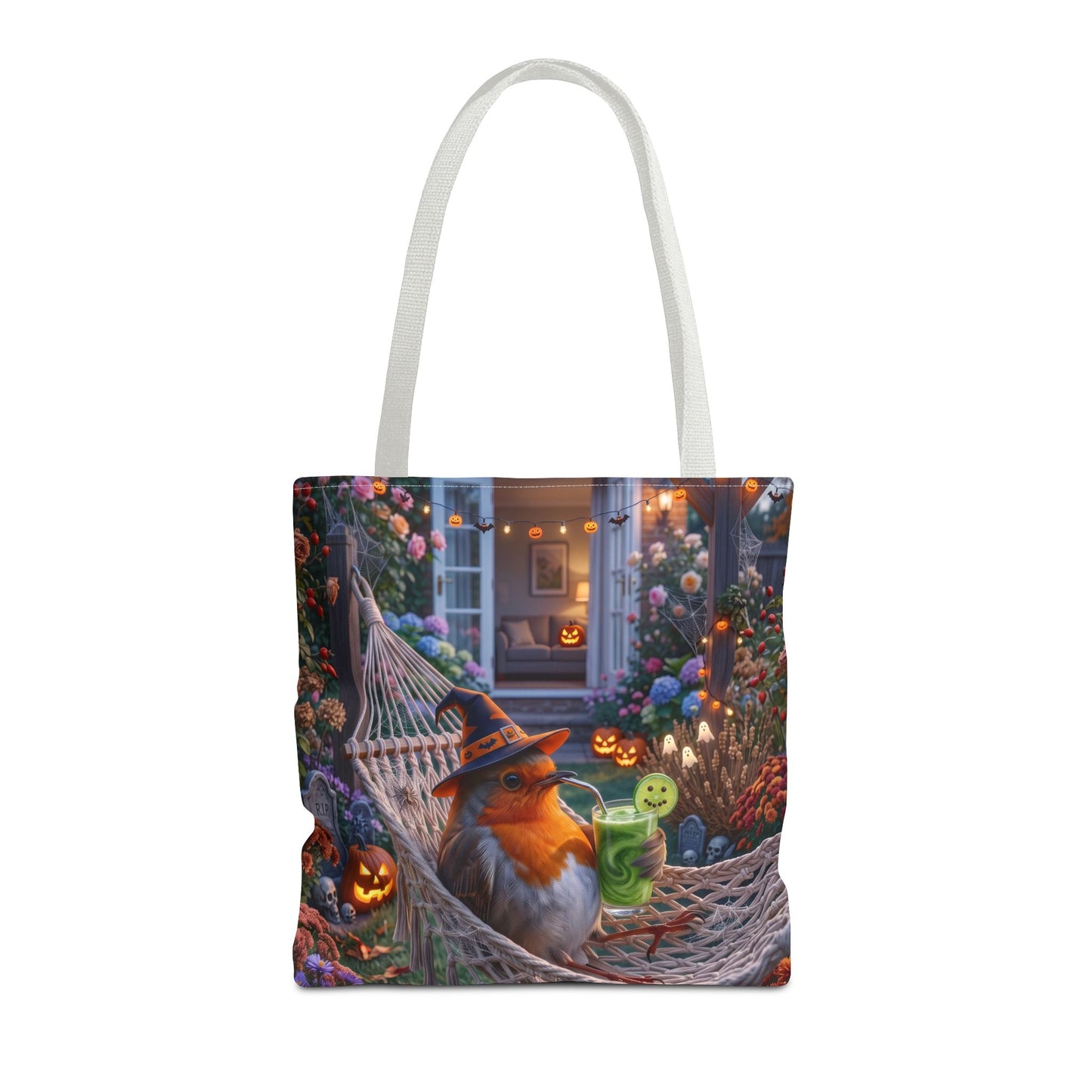 A white canvas tote bag featuring a detailed Halloween-themed illustration of a robin bird lounging in a hammock surrounded by glowing jack-o'-lanterns and flowers.