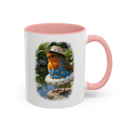A white ceramic mug with a pink interior and handle, featuring a printed illustration of a small bird wearing a straw hat and blue patterned clothing, sitting on a pool float near water.