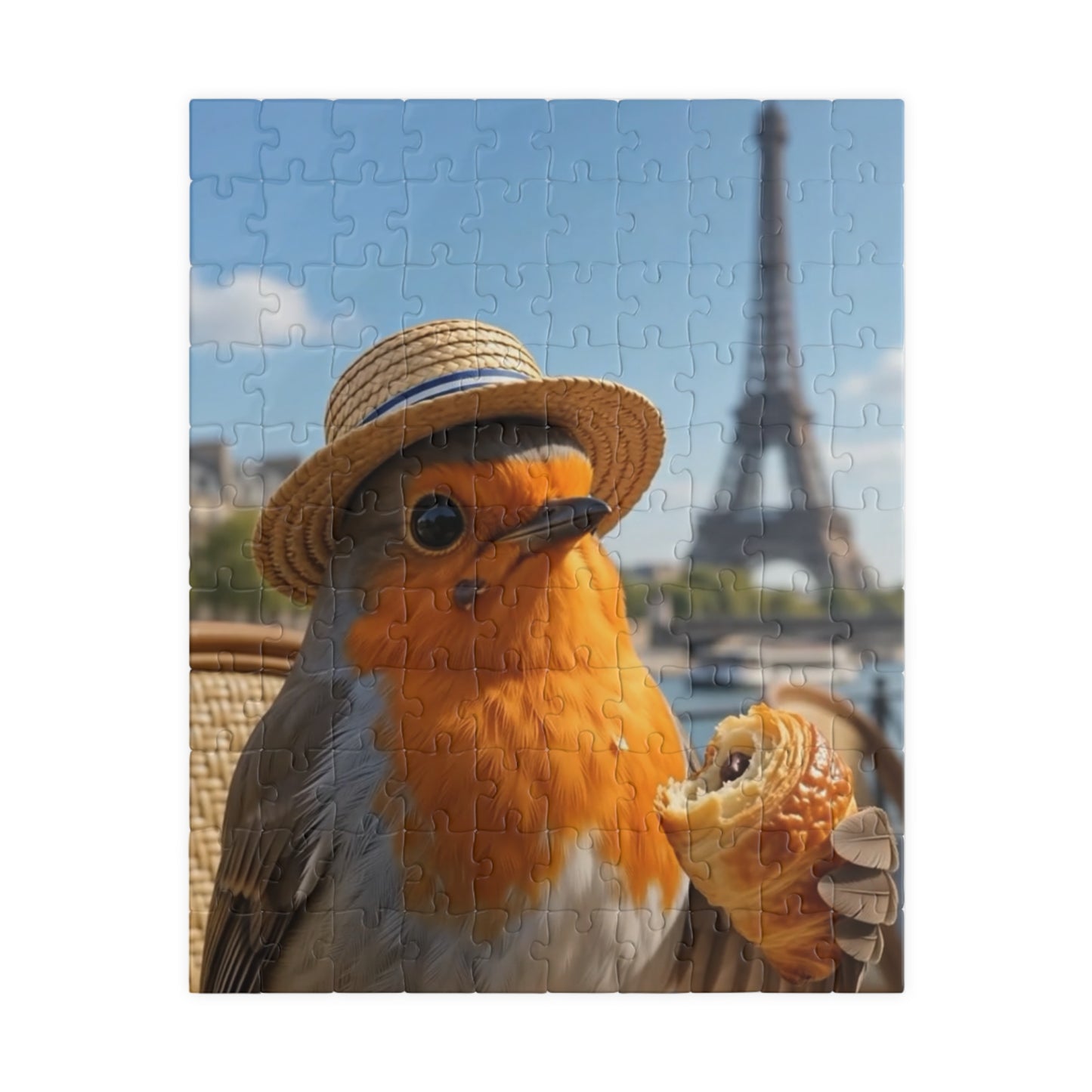A completed jigsaw puzzle featuring a robin wearing a straw hat and holding a pastry, with the Eiffel Tower in the background, shown against a plain white backdrop.