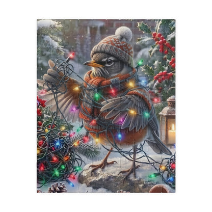 A square jigsaw puzzle featuring a winter holiday scene with a robin wearing a knit hat and scarf, wrapped in multicolored Christmas lights, standing in snow with holly and a lantern.