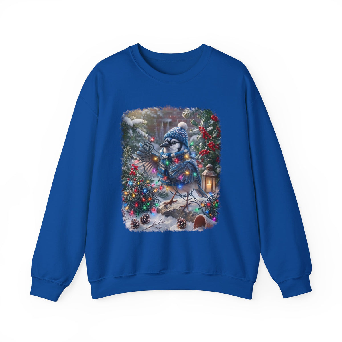 A royal blue crewneck sweatshirt featuring a large, colorful graphic print on the front of a snowy winter forest scene with a blue jay character wearing a knit hat and scarf.