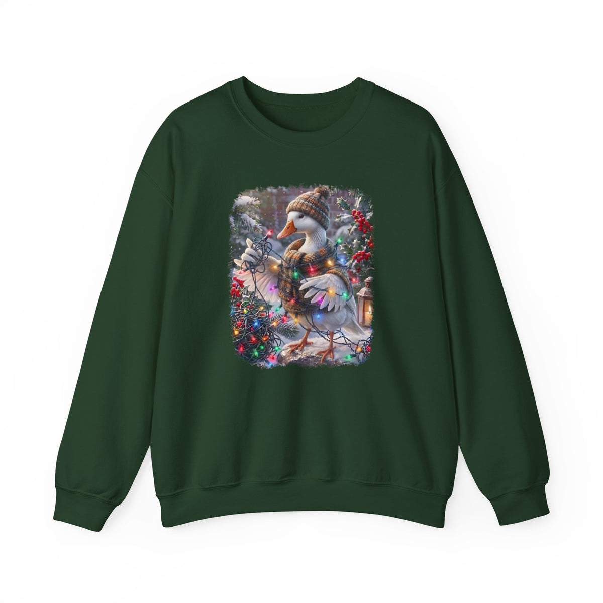 A dark green crewneck sweatshirt featuring a square graphic print on the chest of a snowy goose wearing a knit hat and scarf, surrounded by winter flowers and a lantern.