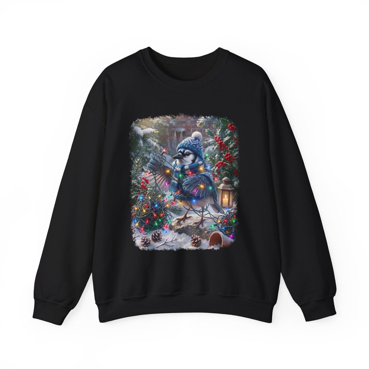 A black crewneck sweatshirt featuring a large, colorful graphic print of a blue jay wearing a winter hat and scarf, surrounded by Christmas trees, ornaments, and a lantern in a snowy outdoor setting.