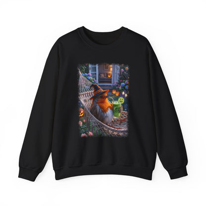 A black crewneck sweatshirt featuring a large, colorful graphic print on the front of an orange robin bird wearing a witch hat and sitting in a hammock surrounded by Halloween decorations.