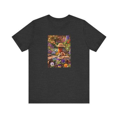 A dark heather gray short-sleeve t-shirt with a colorful graphic print on the front showing a robin bird in a hat surrounded by flowers.