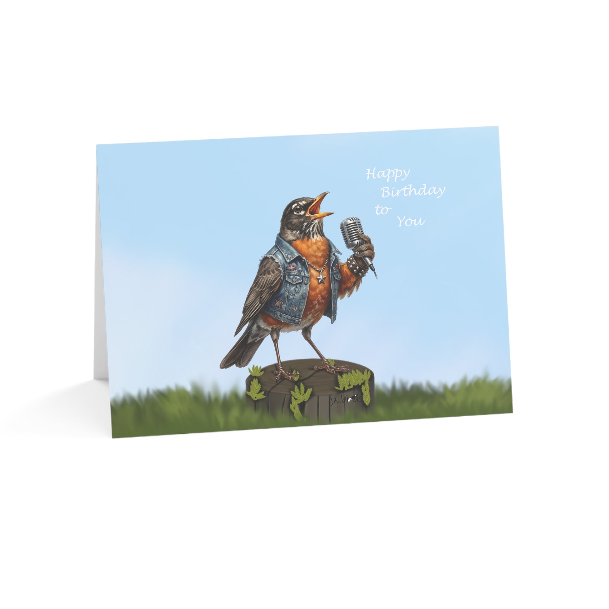 Greeting card with a robin holding a microphone and 'Happy Birthday To You' text on a blue sky background.
