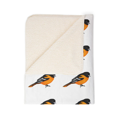 Folded blanket with bird pattern on a white background