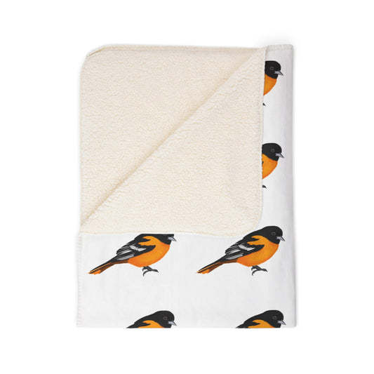 Folded blanket with bird pattern on a white background